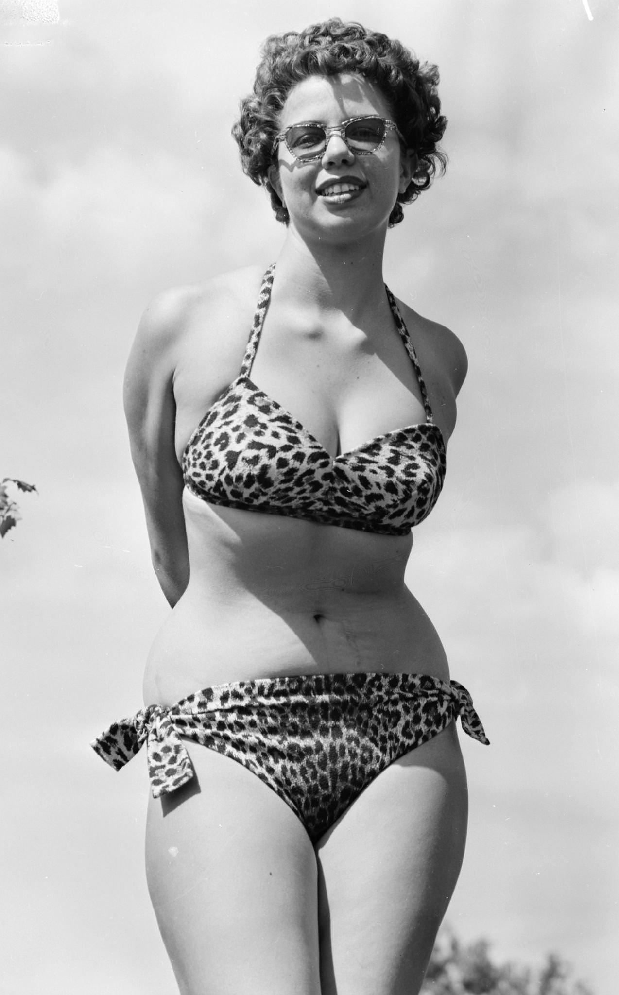 Woman in a leopardskin bikini and sunglasses, 1945.