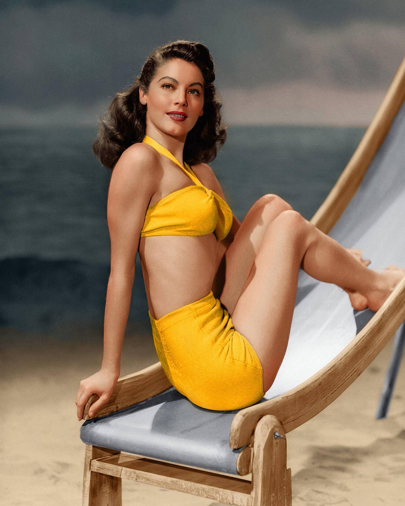 Ava Gardner posing on a deckchair in a yellow bikini, 1945.