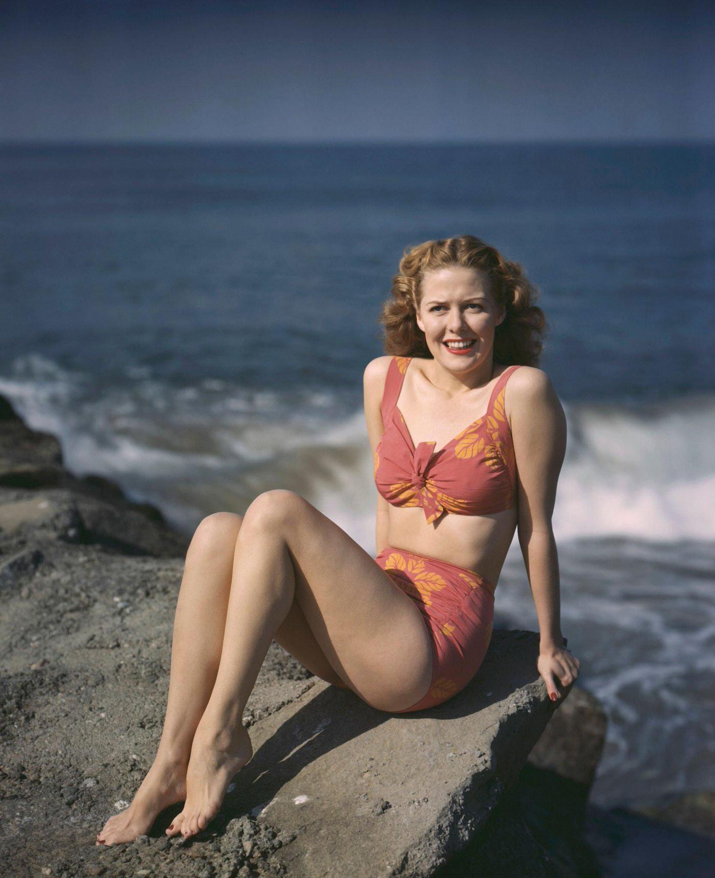 Janis Carter wearing a bikini on the beach, 1945.