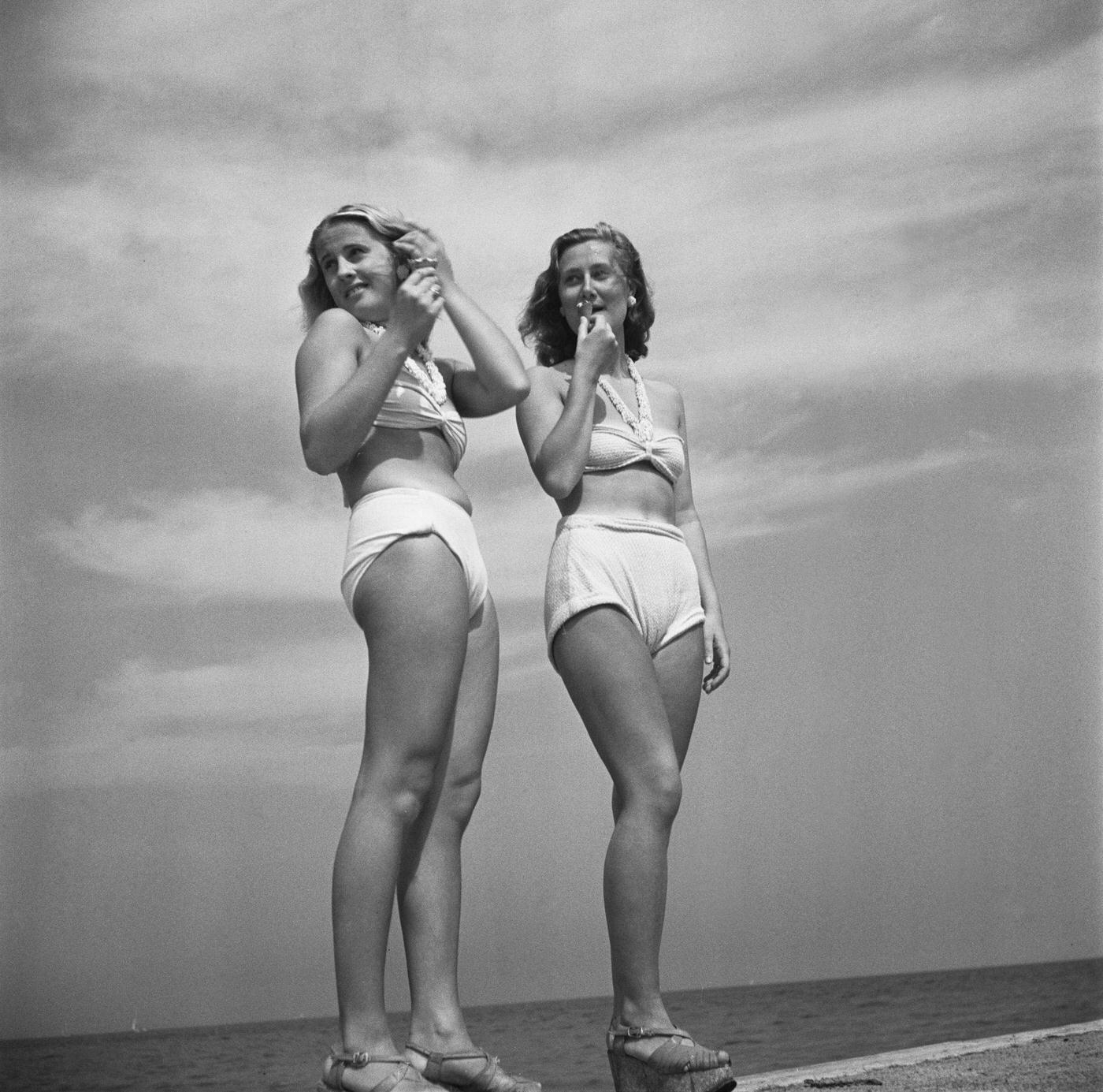 Two young women in bikini swimwear on a jetty at Bellevue Beach, Copenhagen, July 1945.