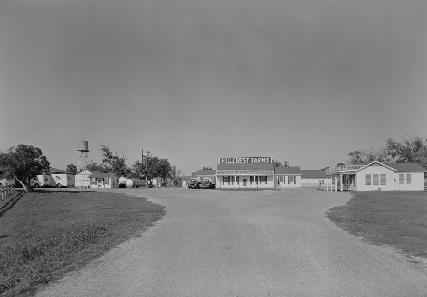 Exterior View of Hillcrest Farms with Trucks, 1957.