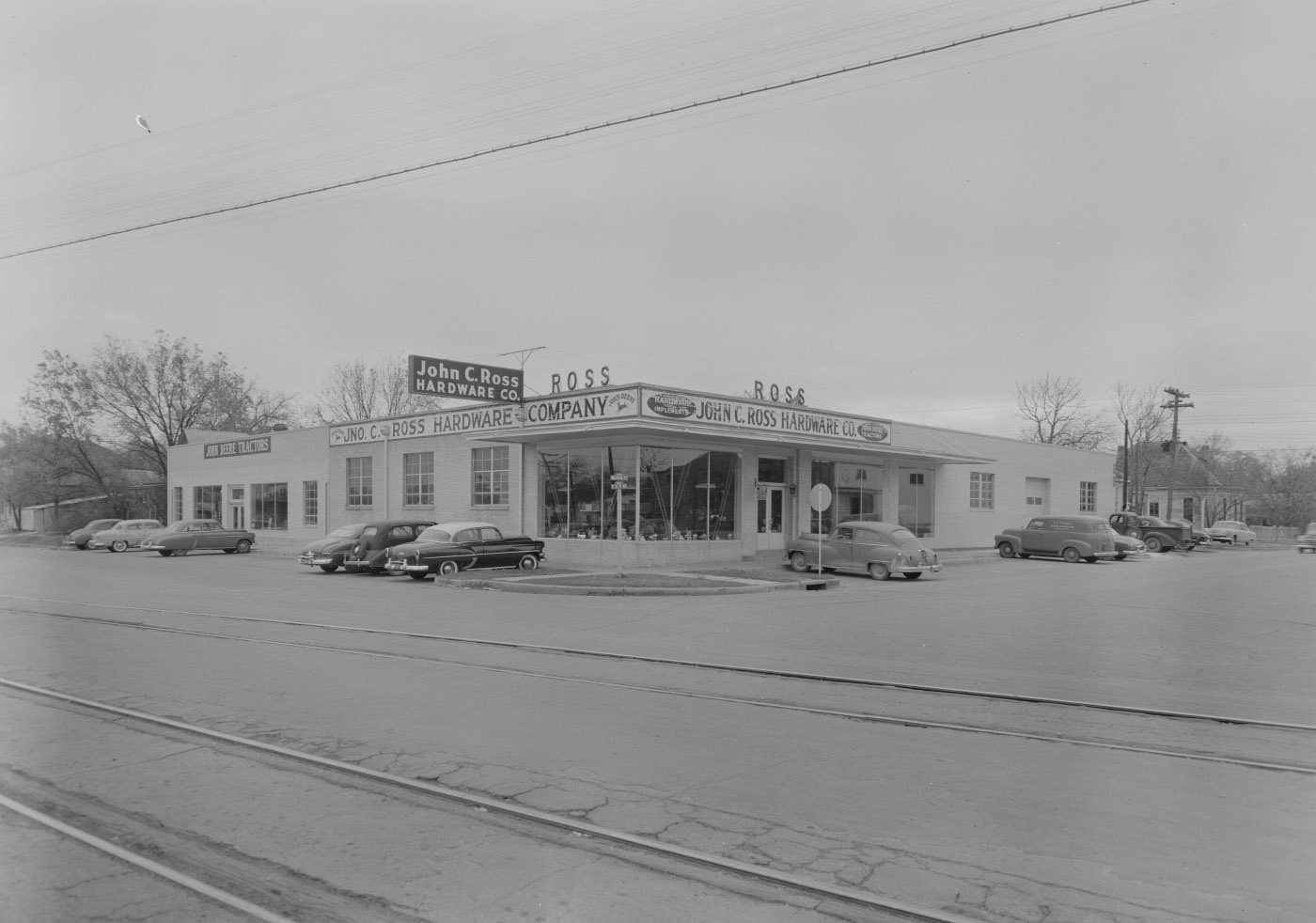 John C. Ross Hardware and John Deere Stores with Cars, 1954.