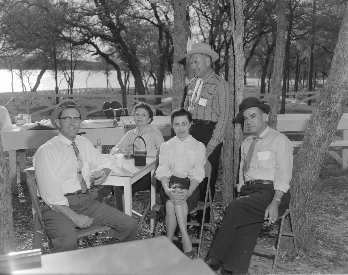Lago Vista Open House BBQ with Guests Seated Outdoors, 1958.