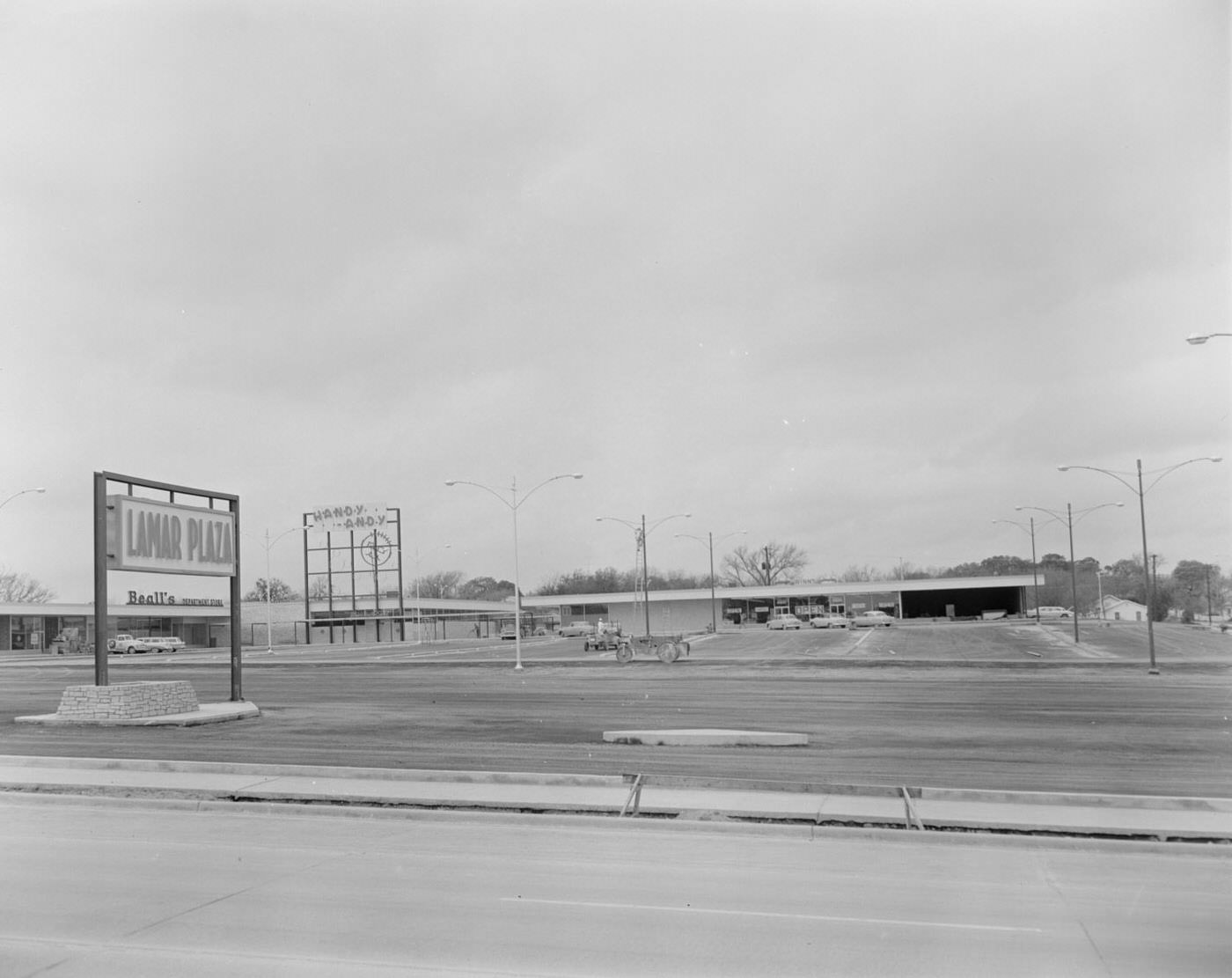 Lamar Plaza Parking Lot and Stores in Background, 1958.