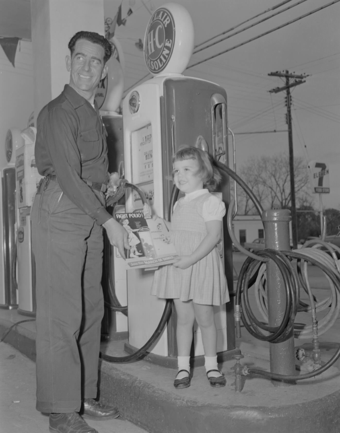 Man and Young Girl at Gas Pump with March of Dimes Magazine, 1956.