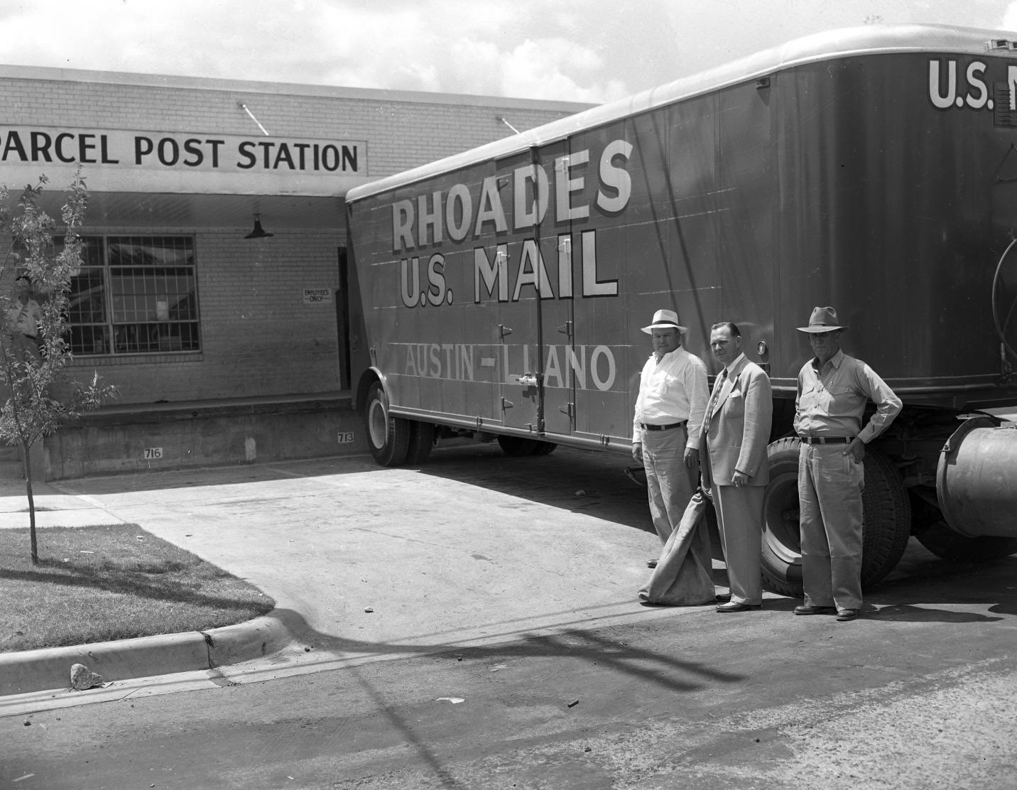 Men Posing in Front of Rhoades Transfer & Storage Truck, 1951.