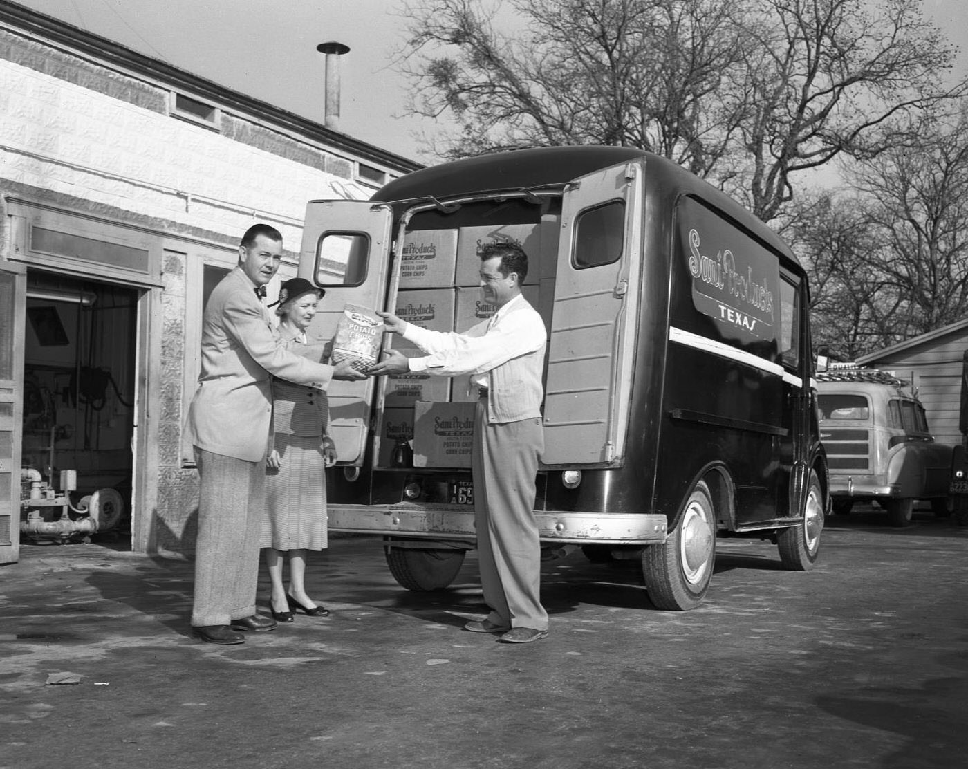 Sani-Products Employee Distributing Snacks from Truck, 1953.