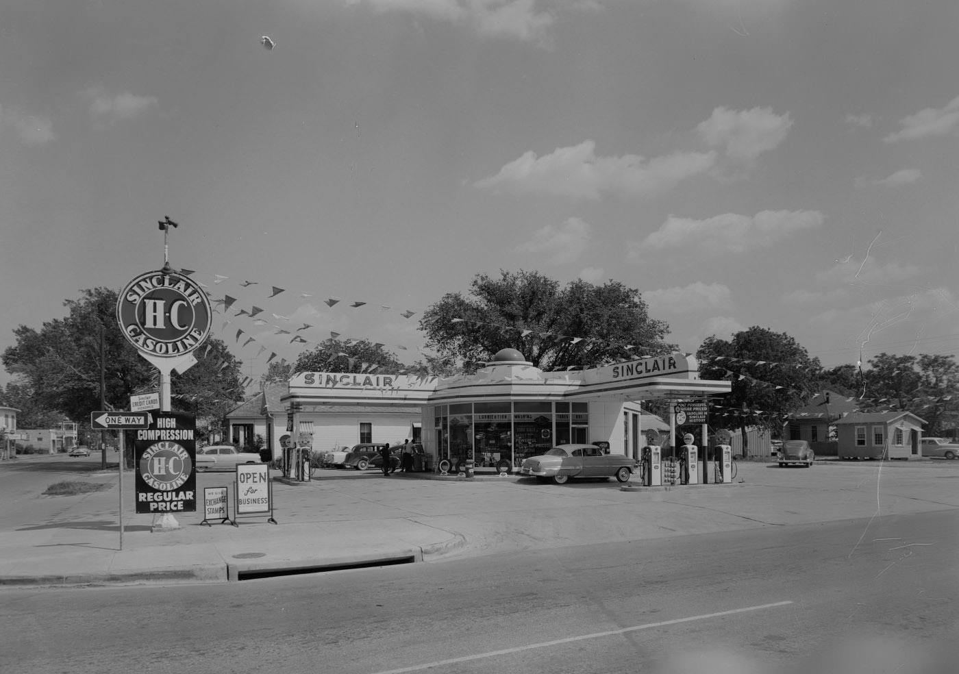 Sinclair Stations, Exterior at 801 E. 1st St. With 3 Men and Parked Cars, 1955.