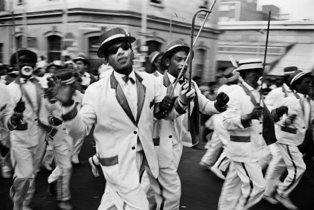 A cultural group, named the Eoan group, was formed among the mainly coloured community. For many years, the organisation entertained the public with ballet performances, operas and plays. Putting one of his tenors through his paces, during a break in building stage props, is director Joseph Manca. District Six, Cape Town, South Africa.