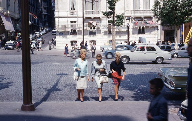 Three ladies crossing the street in Paris, France, circa 1960
