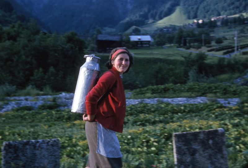 Lady carrying water, somewhere in Switzerland, circa 1964