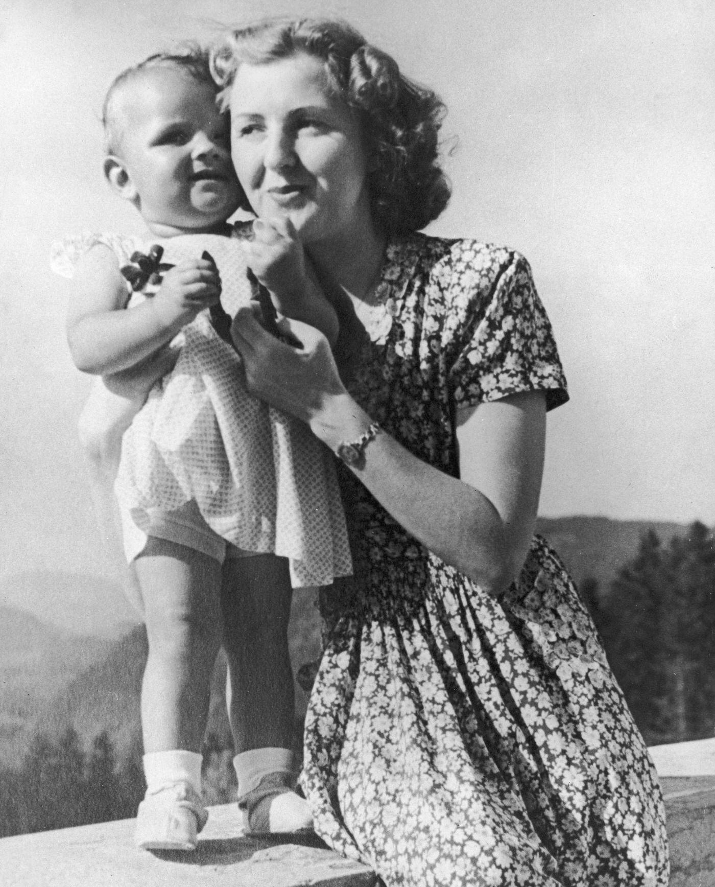 Eva Braun poses on a terrace with an infant, still from a home movie taken by her sister, circa 1942