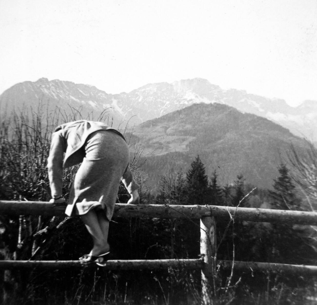 Eva Braun climbing a fence in 1930s or 1940s Germany