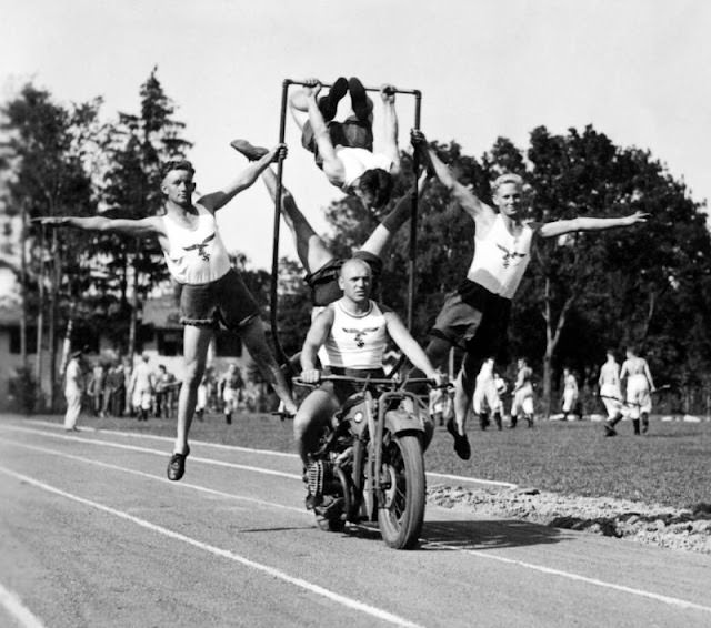 Members of the German Luftwaffe showing off cycling acrobatic skills, circa WWII