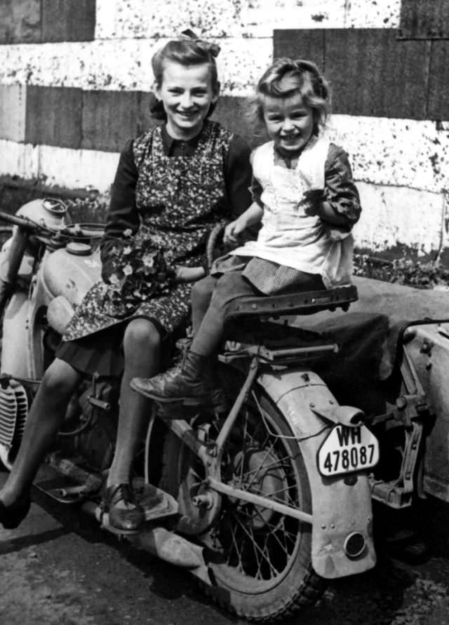 Young German girls sitting on a Wehrmacht motorcycle during WWII