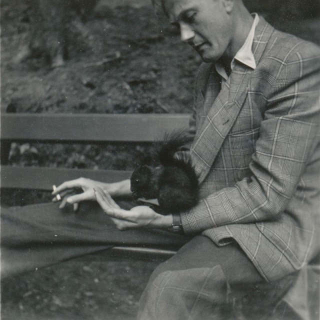 Channeling Le Samouraï. Instead of a small bird in a cage, he's got a squirrel friend in the park, Germany, circa 1950s