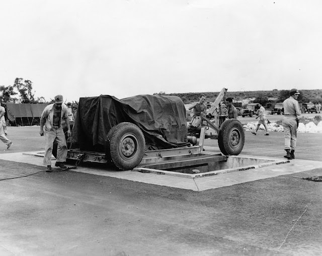 The towing cable is disconnected. Note the MPs keeping guard.