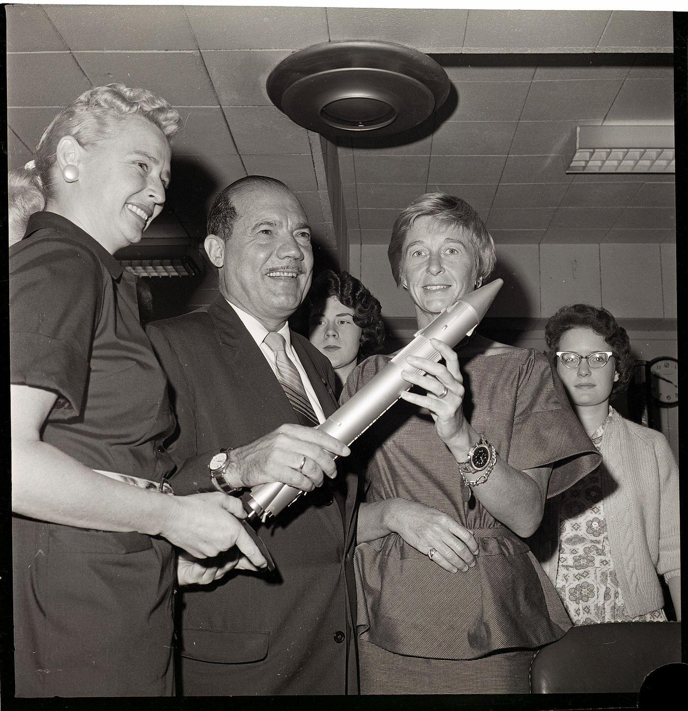 Senator and Two Women Holding Missile Model, 1962