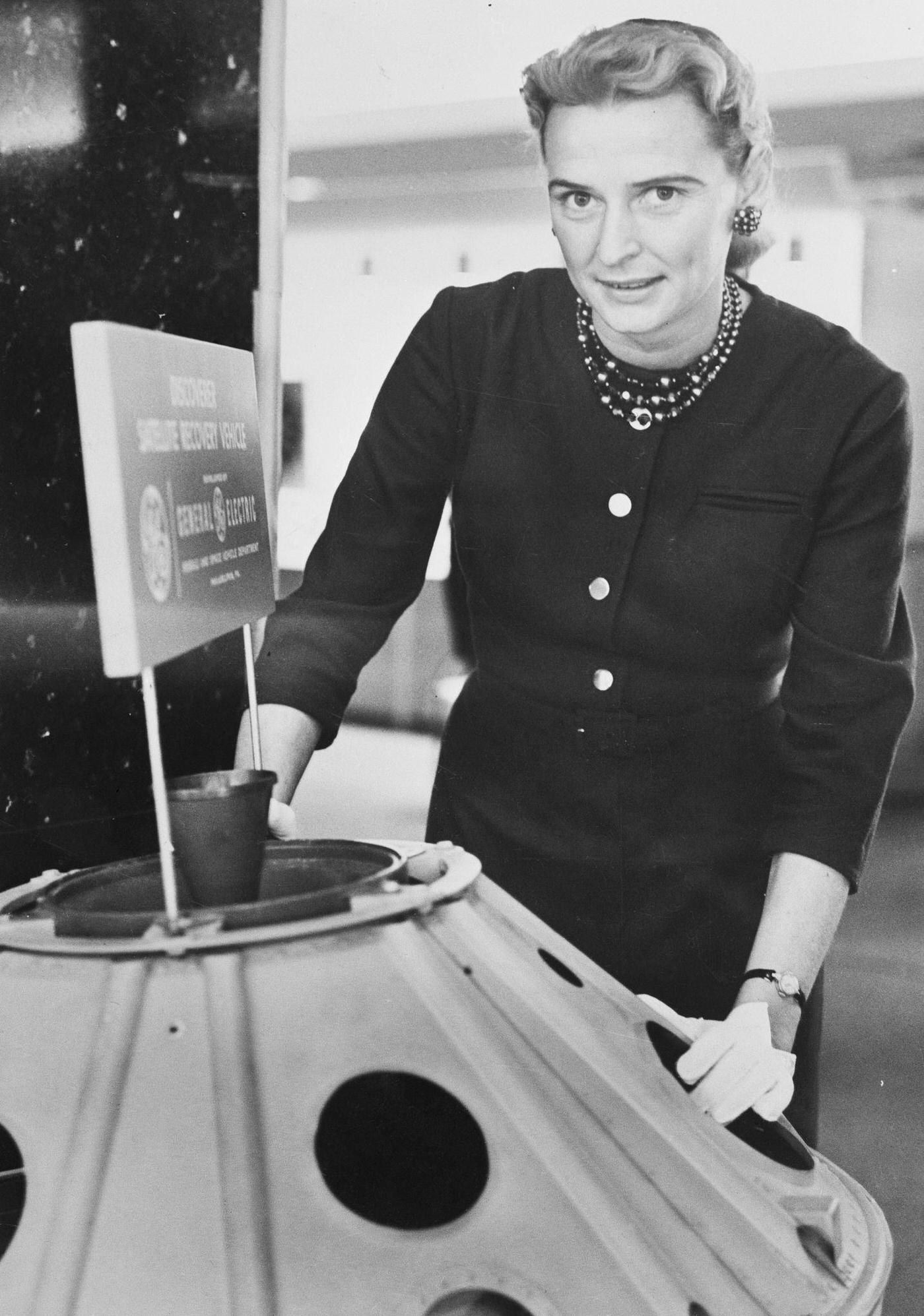 Jerrie Cobb Standing Near Satellite Model, 1950s