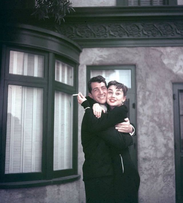 Dean Martin and Audrey Hepburn embrace on the set of "Sabrina", 1954