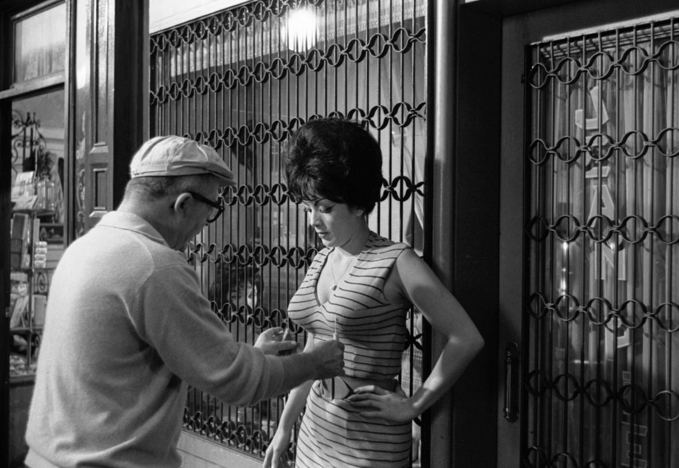 Director Billy Wilder and actress Tura Satana on the set of "Irma la Douce," Hollywood, California, 1962