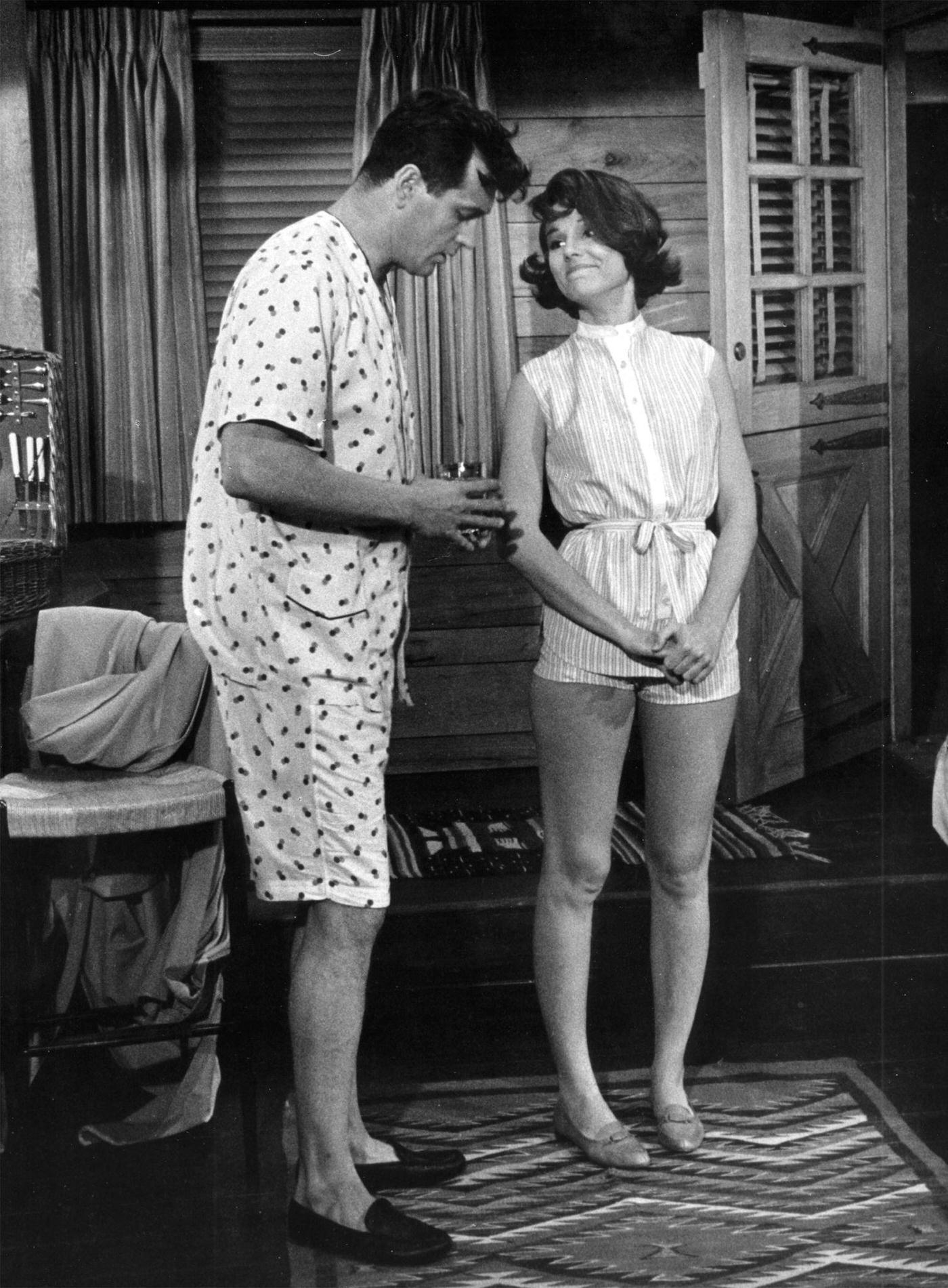 Rock Hudson and Paula Prentiss in pajama, filming "Man's Favorite Sport?," Los Angeles, California, 1963