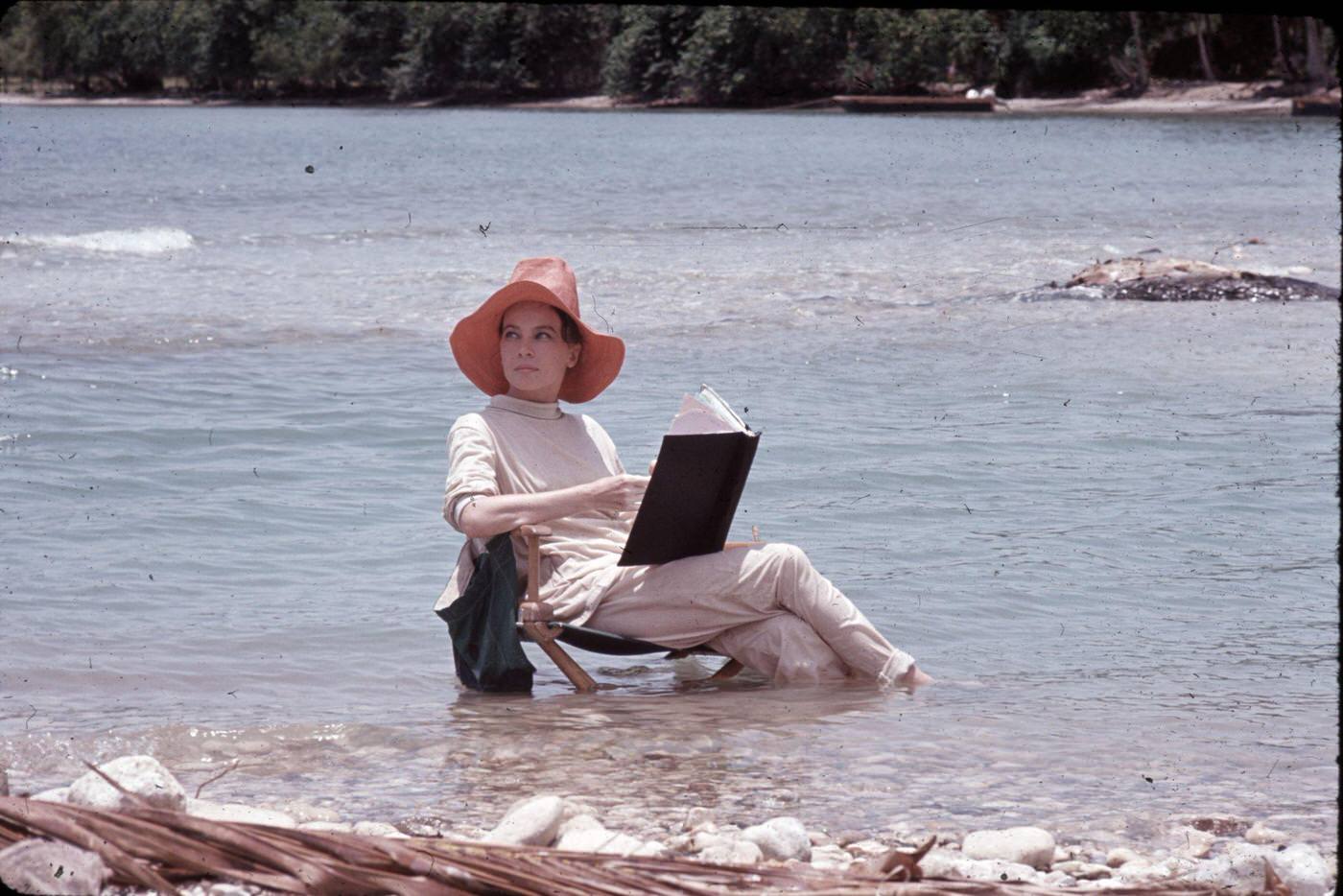 Leslie Caron reading in the ocean for "Father Goose," Ocho Rios, St. Ann, Jamaica, 1963