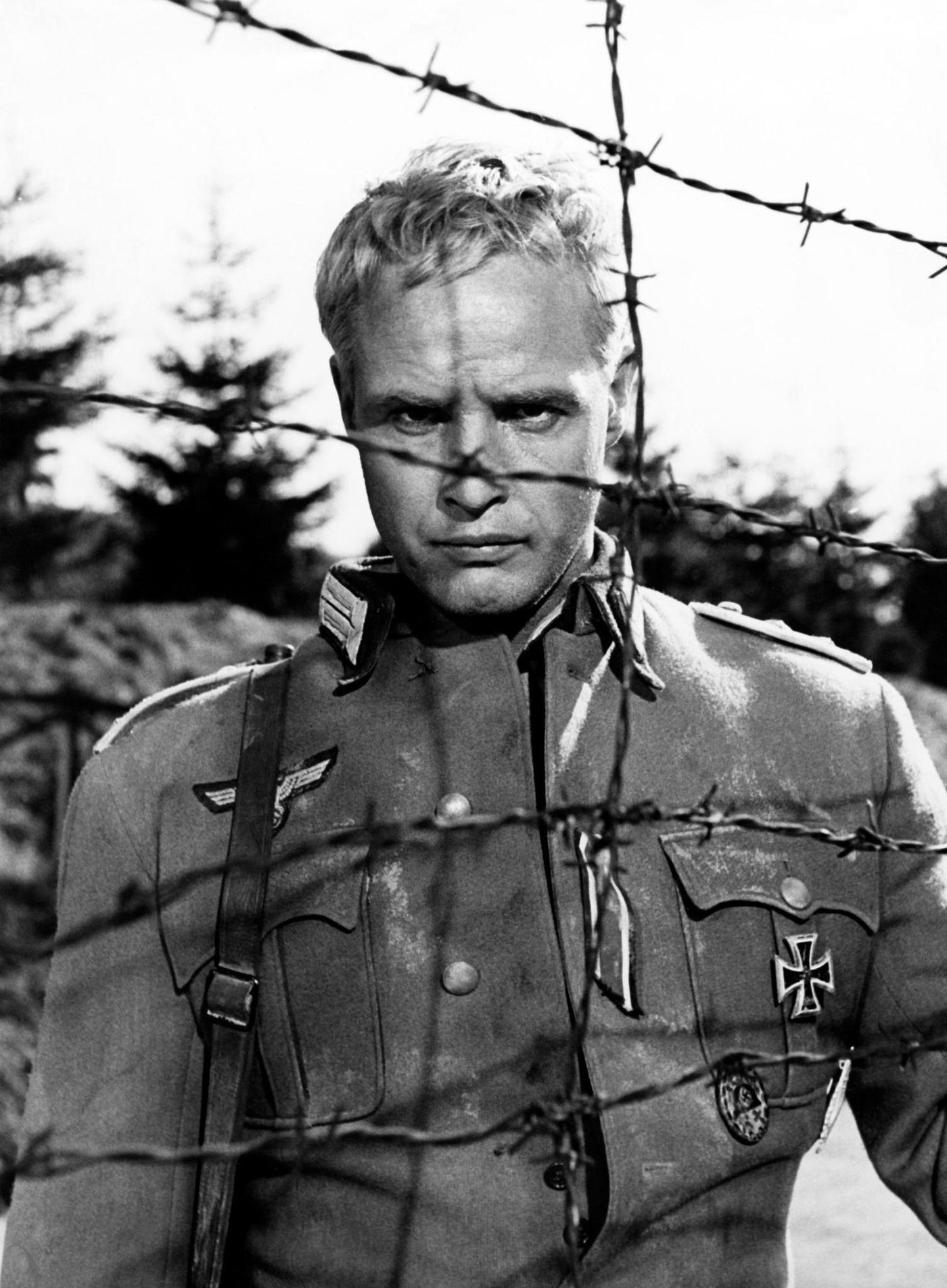 Marlon Brando behind barbed wire, shooting "The Young Lions," Natzweiler-Struthof Concentration Camp, France, 1957