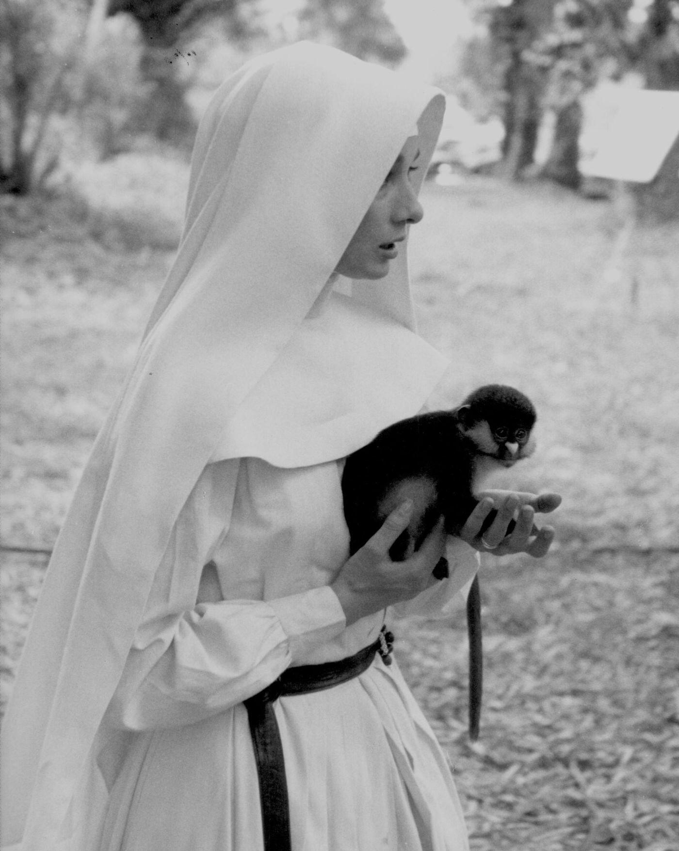 Audrey Hepburn with a monkey on the set of "The Nun's Story," Congo, 1958