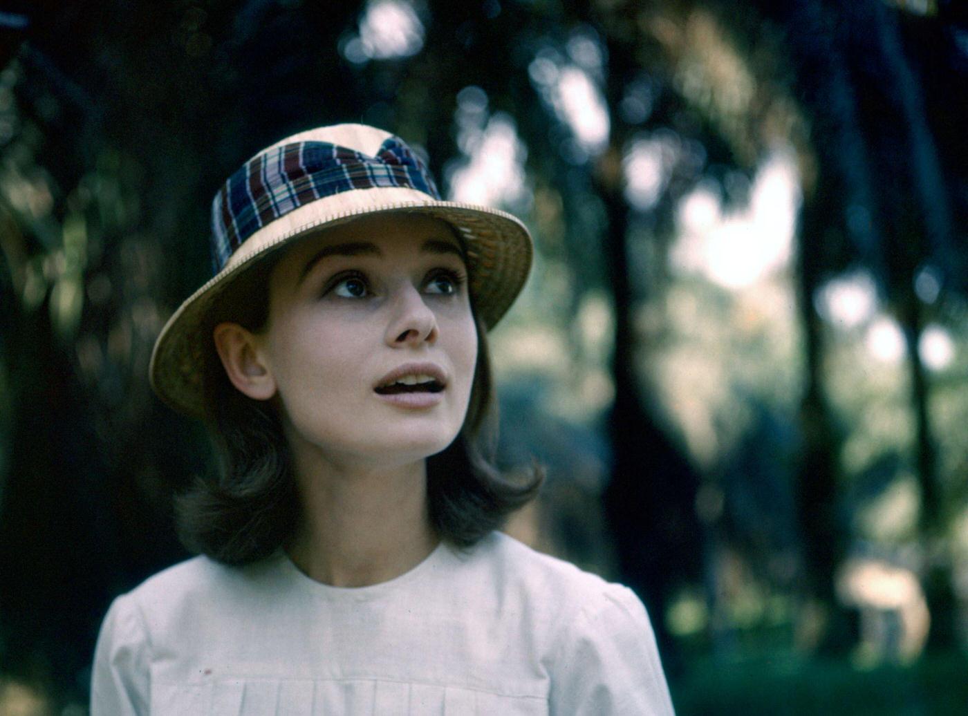 Audrey Hepburn poses with a hat near the rainforest in the Democratic Republic of Congo, 1958.
