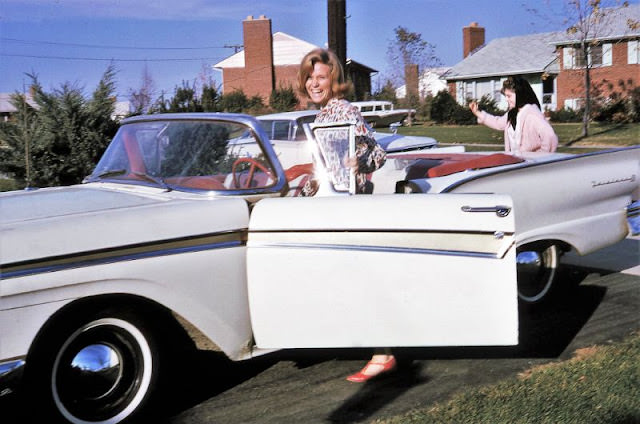 Two Girls Hurrying to a 1957 Ford Fairline Convertible