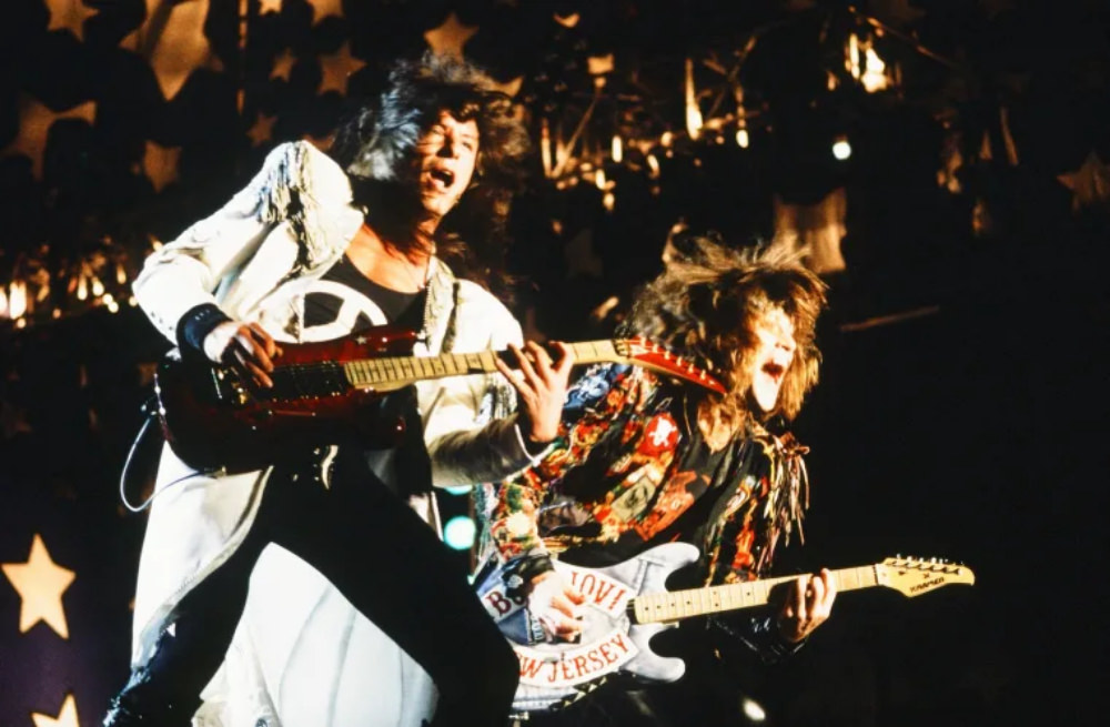 Jon Bon Jovi and Richie Sambora hit the Lenin Stadium stage at night to rock.