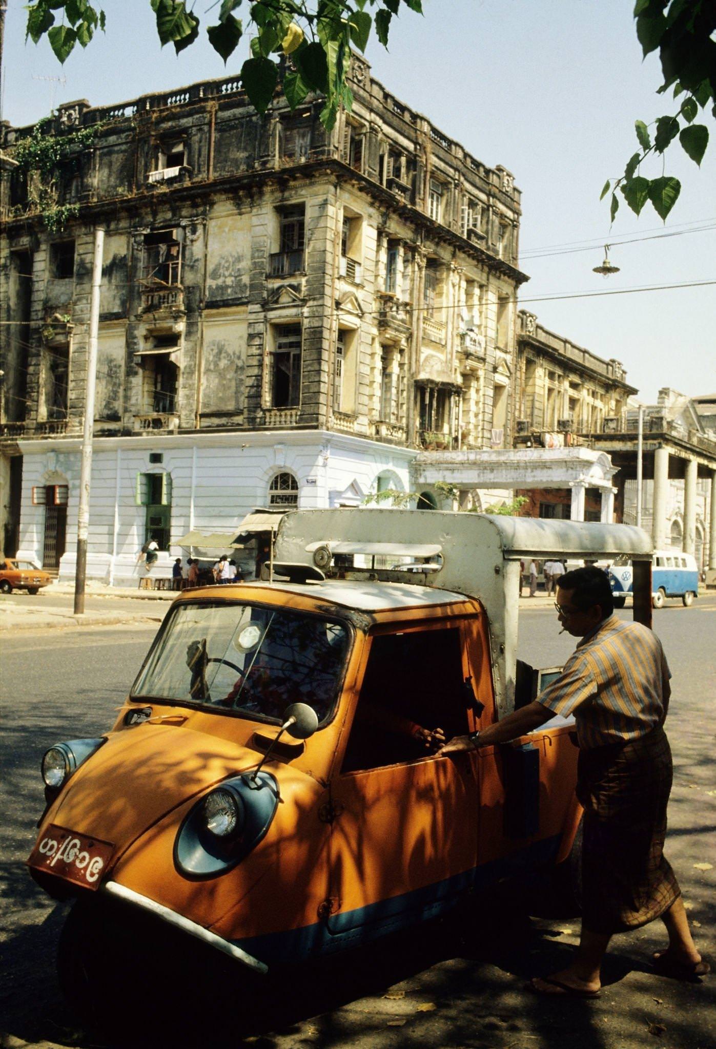 Orange-Coloured Auto Rickshaw Picks Up a Male Passenger in Rangoon, Burma, 1985