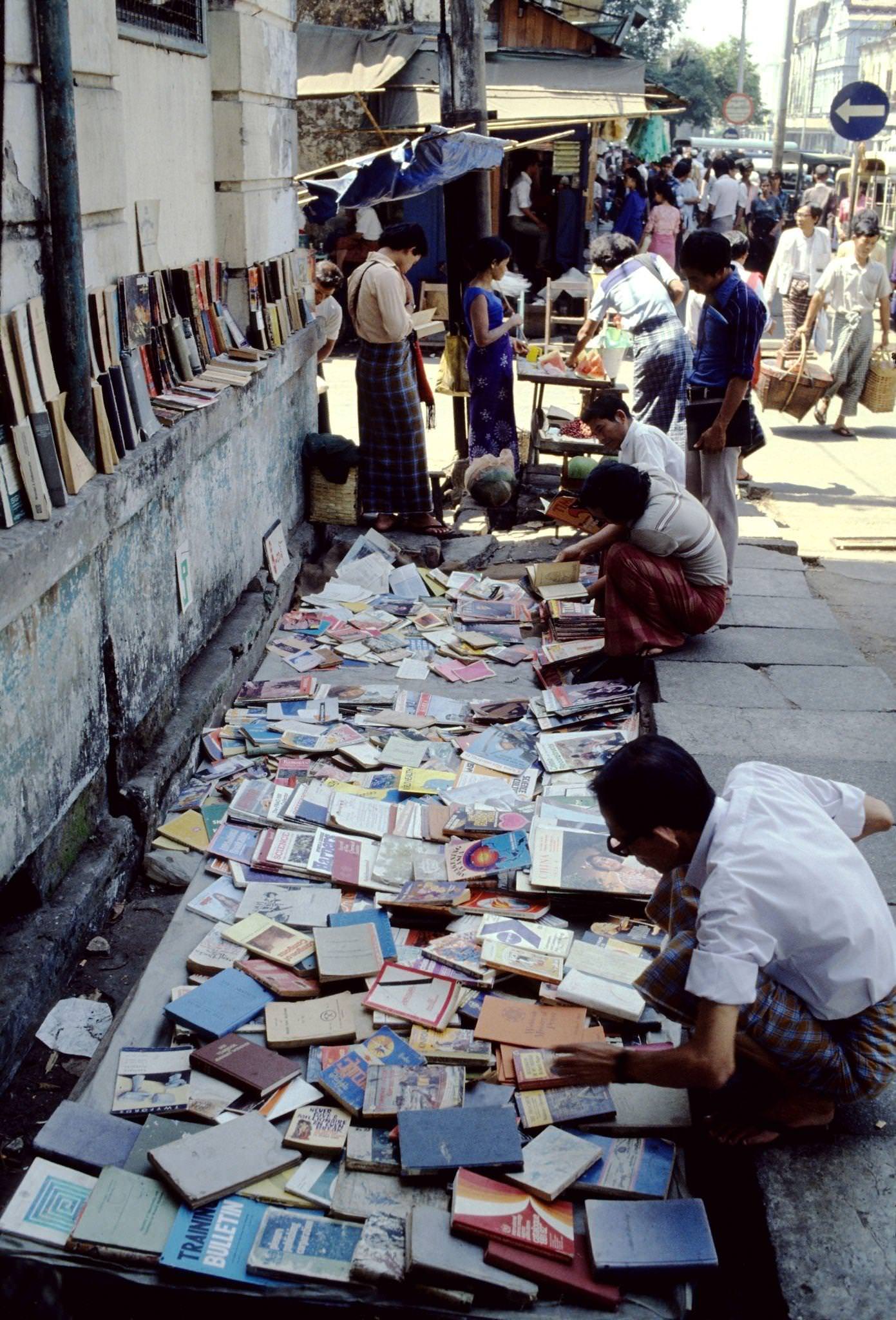 Street Vendor Offers Pre-Owned Magazines and Books at a Kerb-Side Stall in Rangoon, Burma, 1985