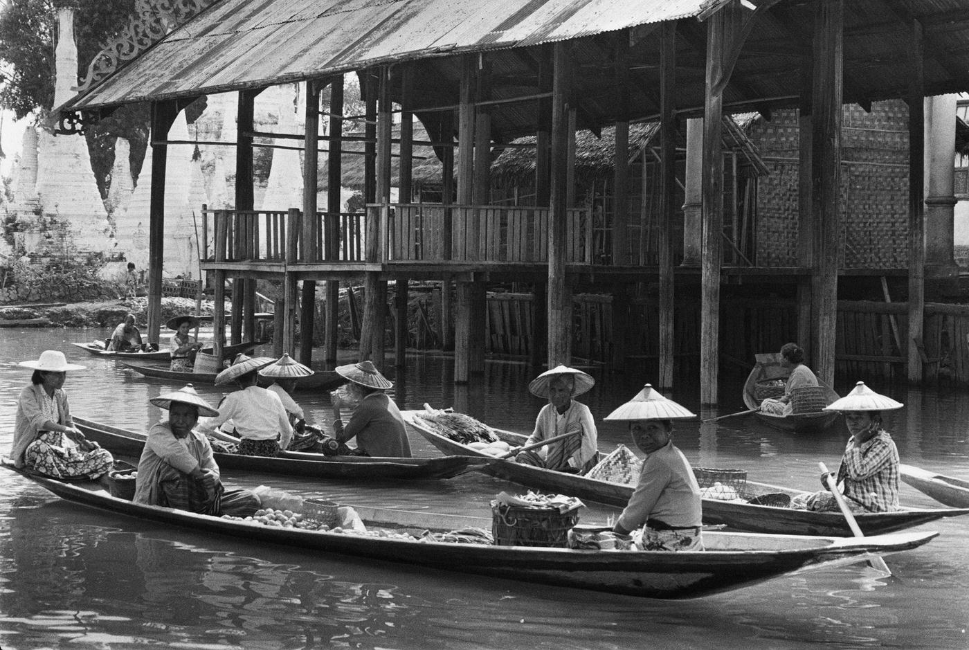 Women sell goods from boats at a floating market on Inle Lake, Taunggyi District, Burma, 1988.