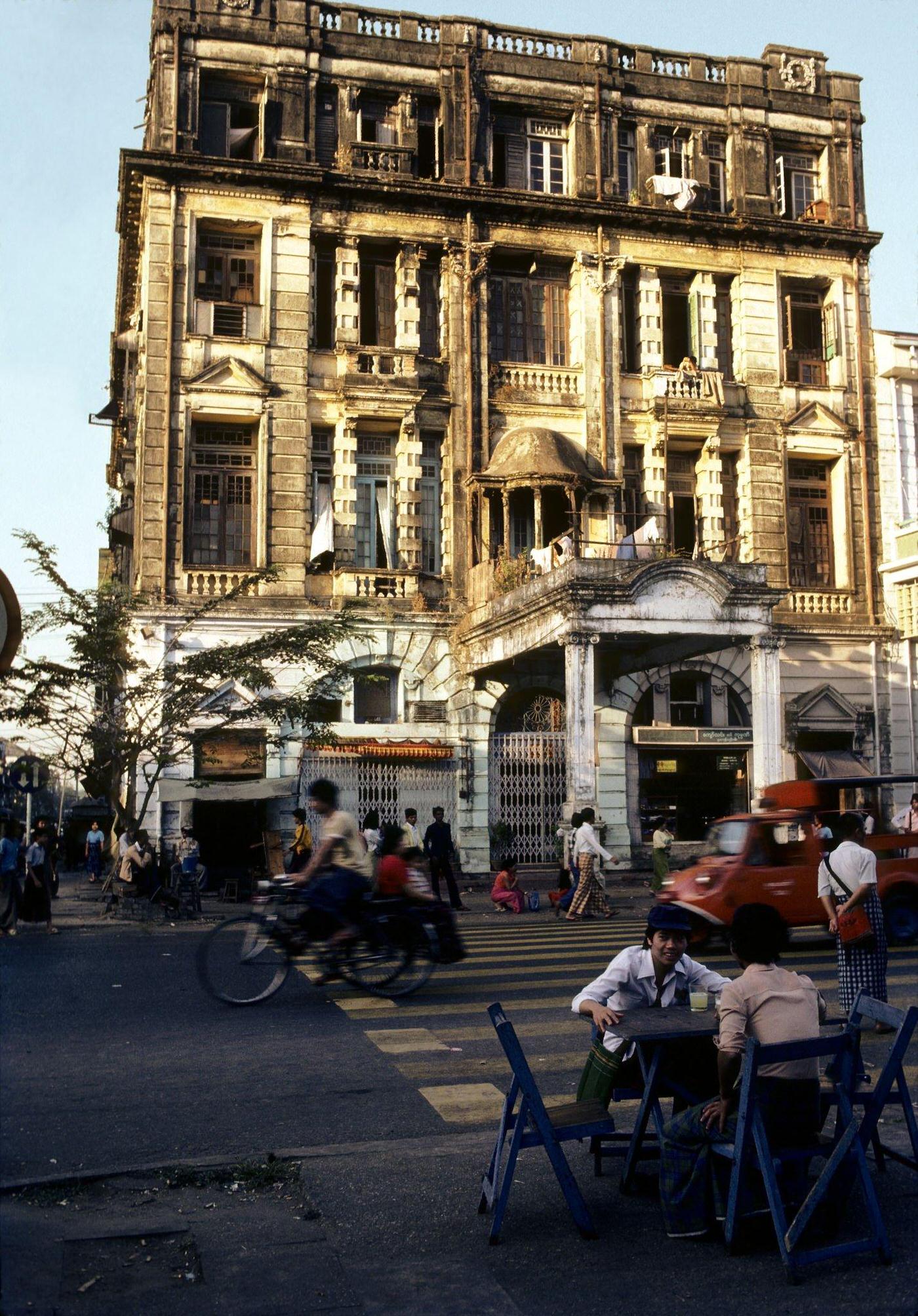 Couple Enjoying Fresh Lemonade at a Kerbside Restaurant, Sun Sets on a Busy Street in Rangoon, Burma, 1985