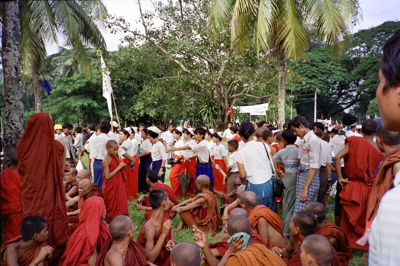 Buddhist monk and Burmese demonstrators at a rally led by Aung San Suu Kyi in Yangon, 1988.