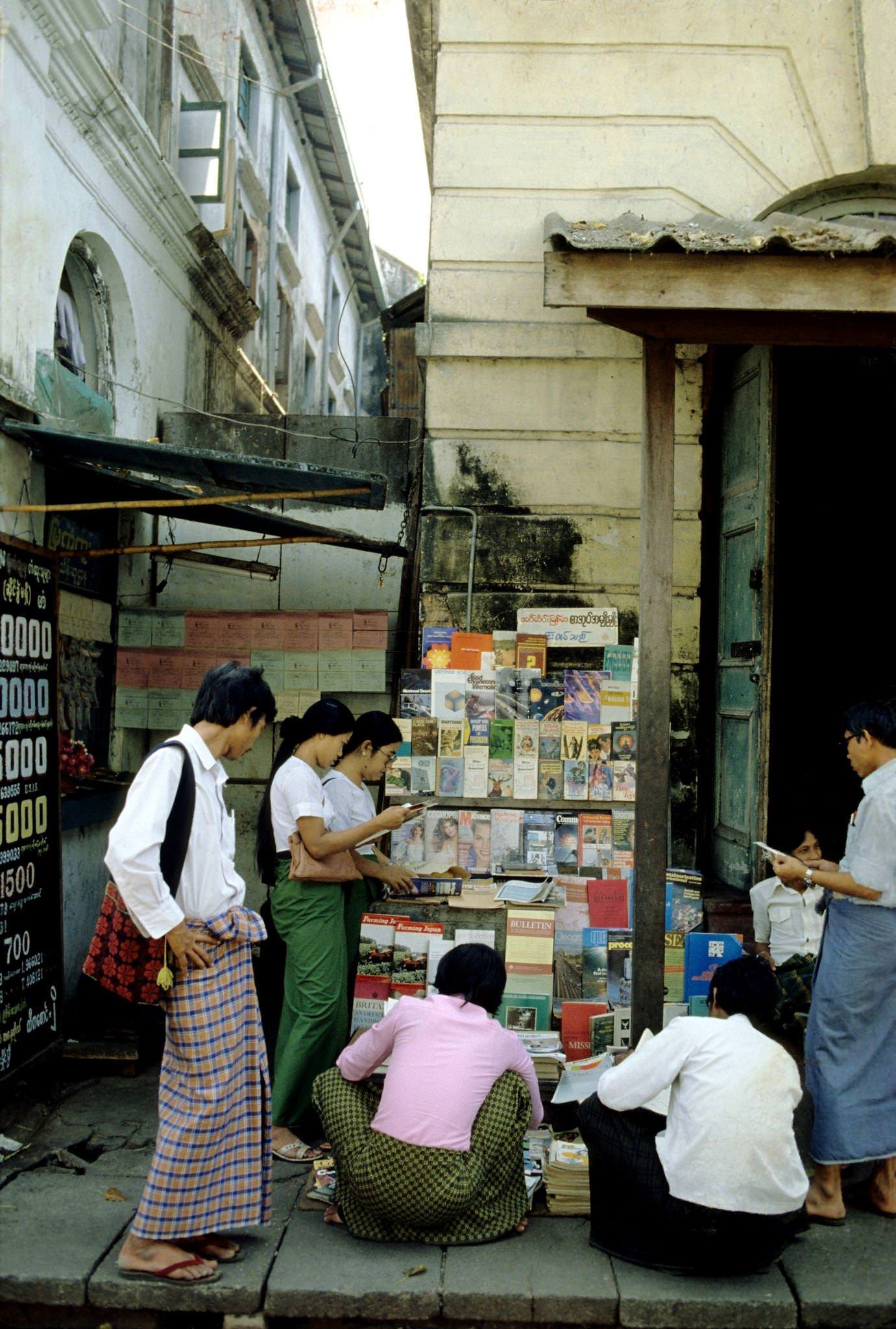 Street Vendor Offers Pre-Owned Magazines and Books at a Kerb-Side Stall in Rangoon, Burma, 1985