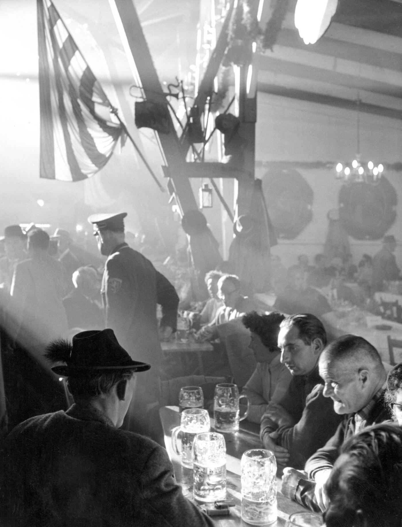 Atmosphere of Oktoberfest with beer and food, 1961.