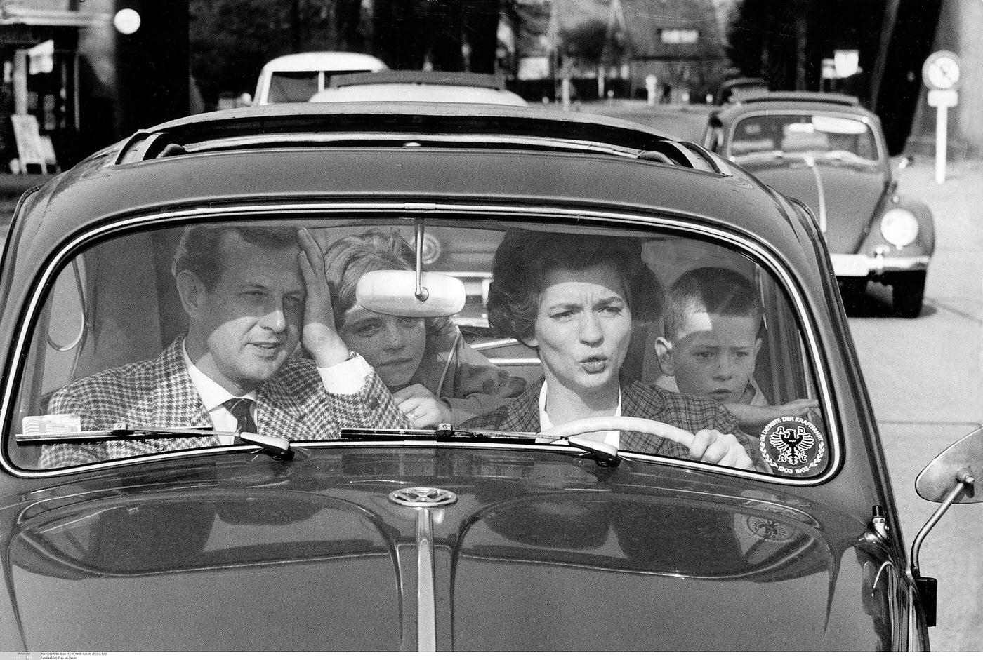 Family driving, critical moment captured. 1963.