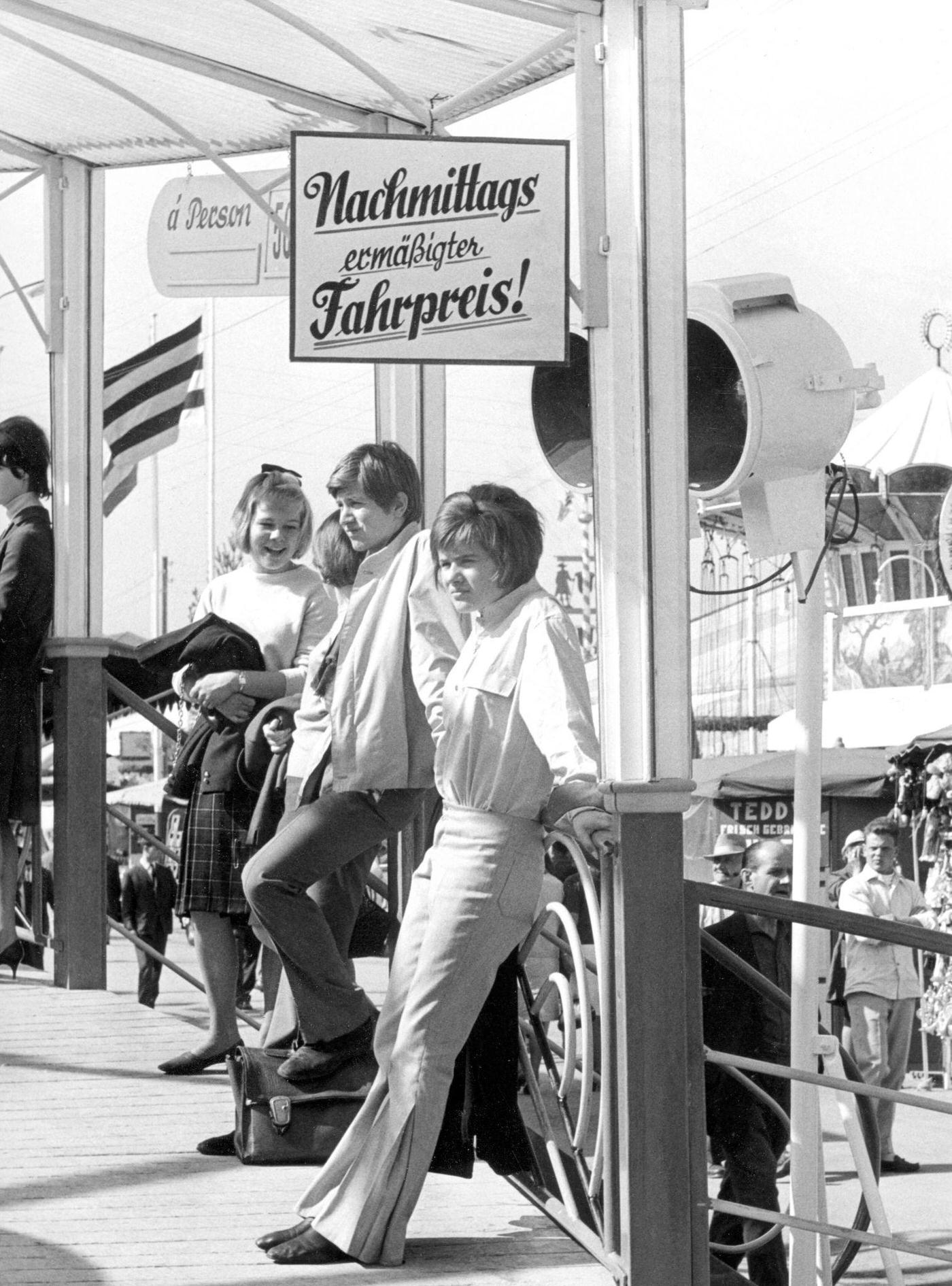 Youth at Oktoberfest in Munich, enjoying a ride. 1965.