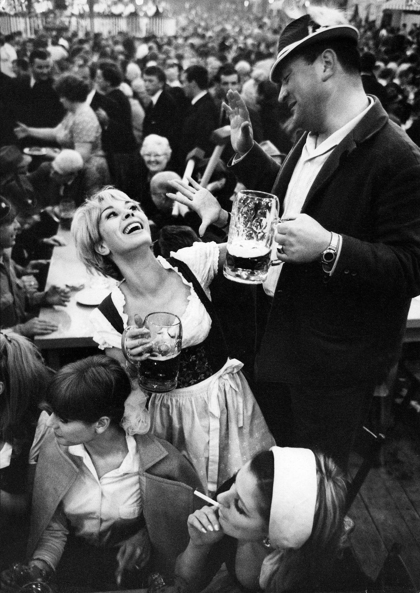 People drinking beer in a beer tent, 1968.