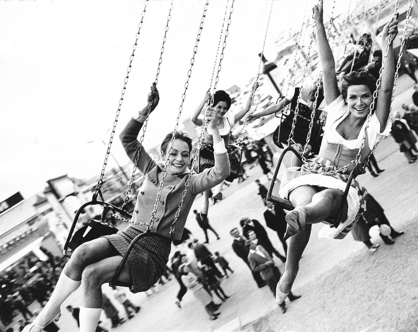 Women on a chairplane at Oktoberfest, 1969.