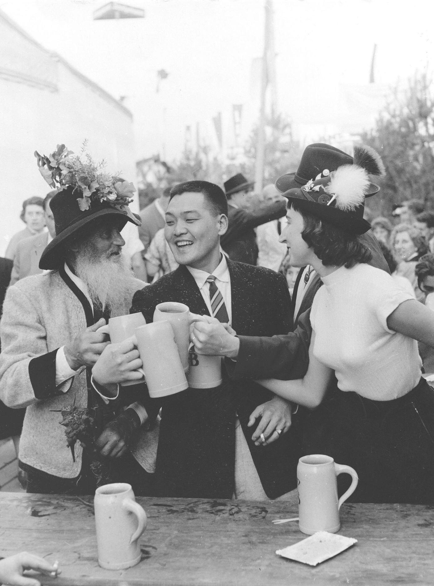 Japanese tourists enjoy Oktoberfest with Bavarians, 1960.