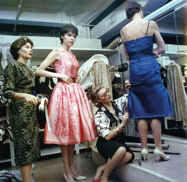 Pauline Trigere Fitting a Dress on a Model with Sue Ellen Gigli Trying on a Pink Dress, 1962