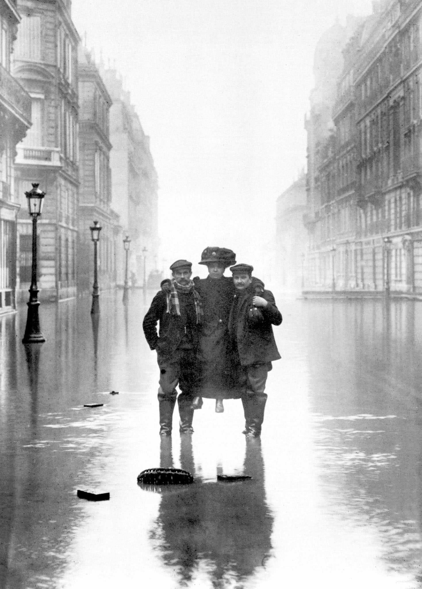 Men carrying a woman during floods in Paris, 1910.