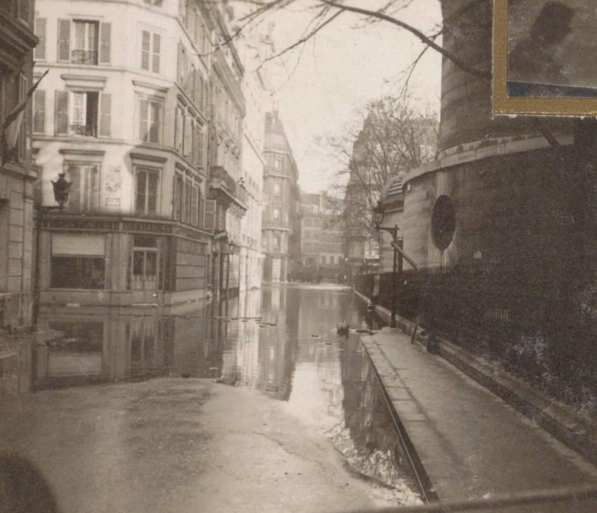 Partially flooded street during Paris flood. Part of photo album flooding Paris and suburbs 1910.