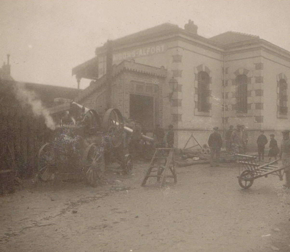 Men with wheelbarrows and a machine at Maisons-Alfort railway station during the Paris flood of 1910.