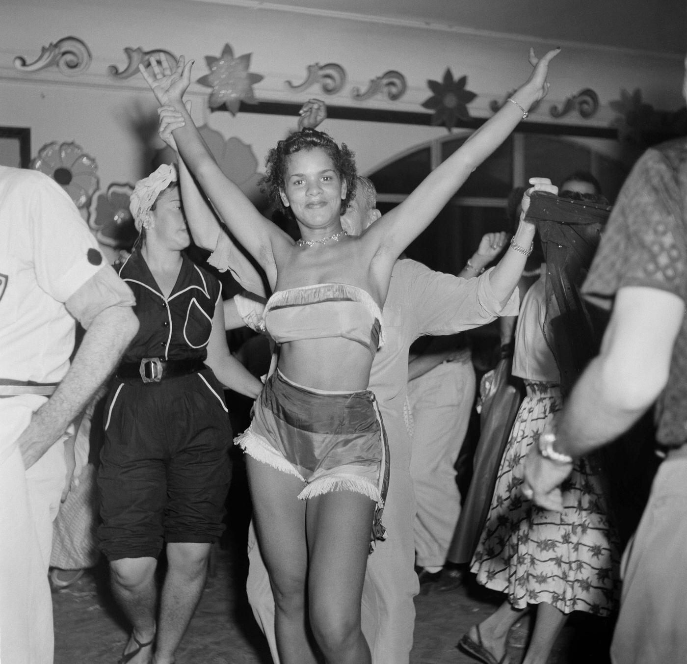 Parade reveler poses at a party during Rio de Janeiro's Carnival. 1953