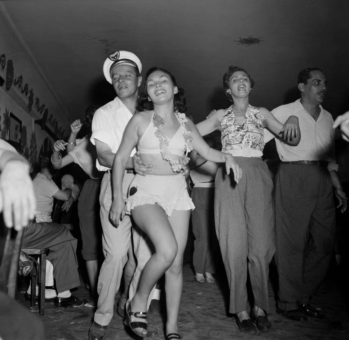 Carnival parade revelers in costumes party in Rio de Janeiro's Carnival. 1953